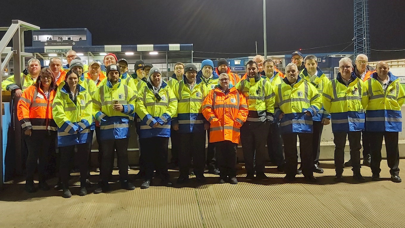 A photograph of Barrow stewards in new coats provided by Deltawaite