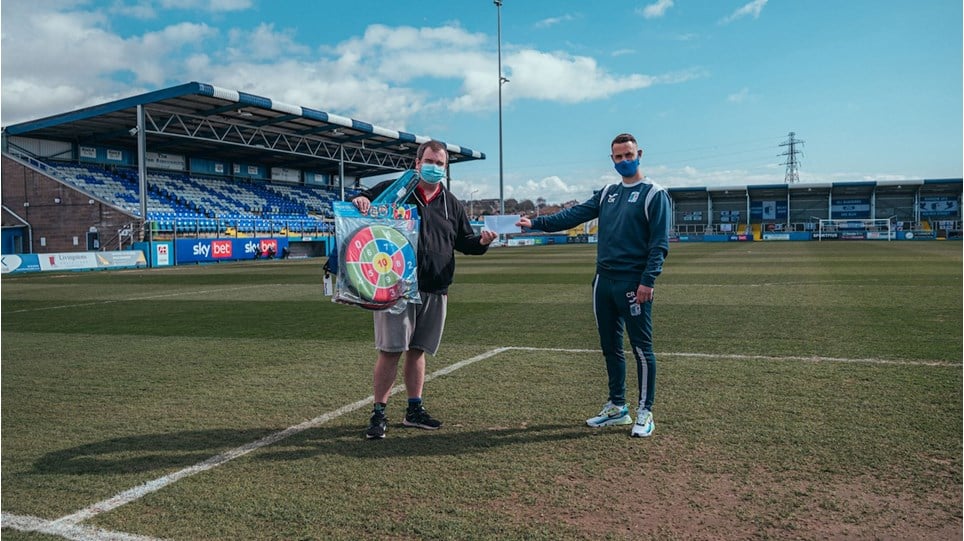 A photograph of Jeff Holt and Craig Rutherford on the pitch at Barrow