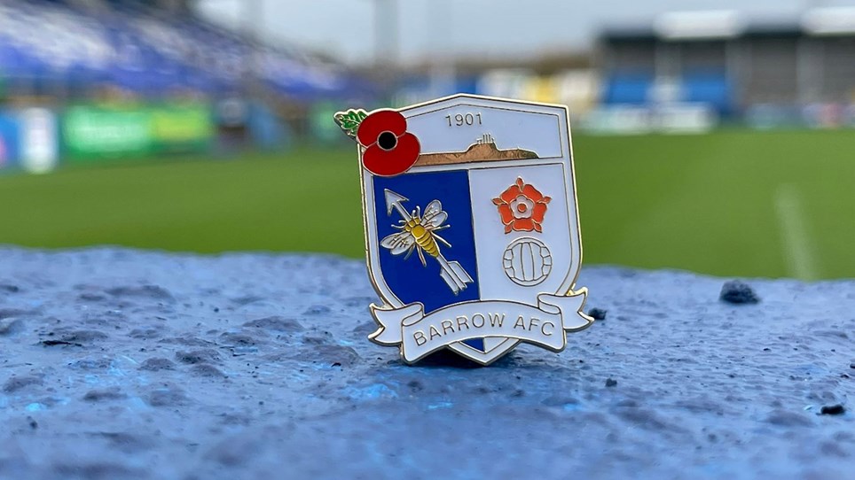 A photograph of the Barrow poppy pin badge that is on sale now from the Club Shop
