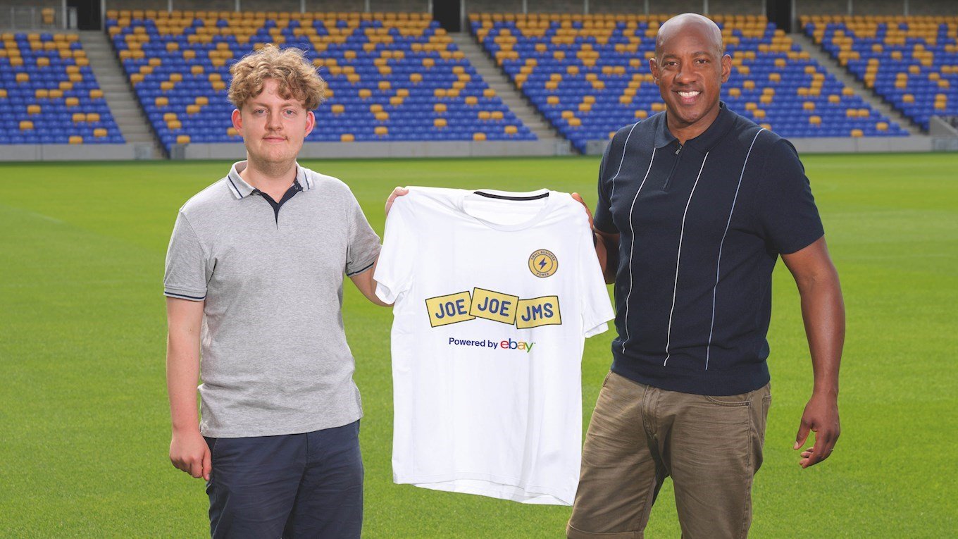 A photograph of Dion Dublin surprising a small business owner