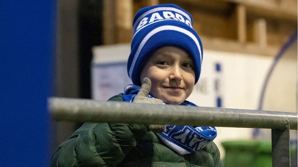 A photograph of a young Barrow fan at The Dunes Hotel Stadium