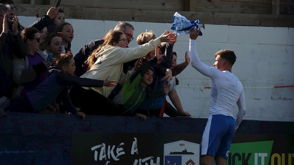 A photograph of Robbie Gotts giving his shirt to some fans at The Dunes Hotel Stadium
