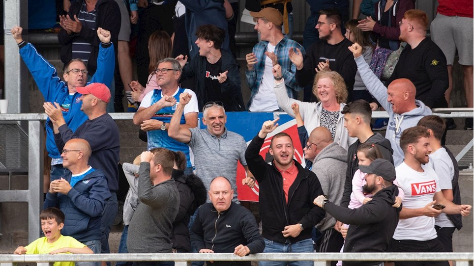 A photograph of Barrow fans celebrating a goal