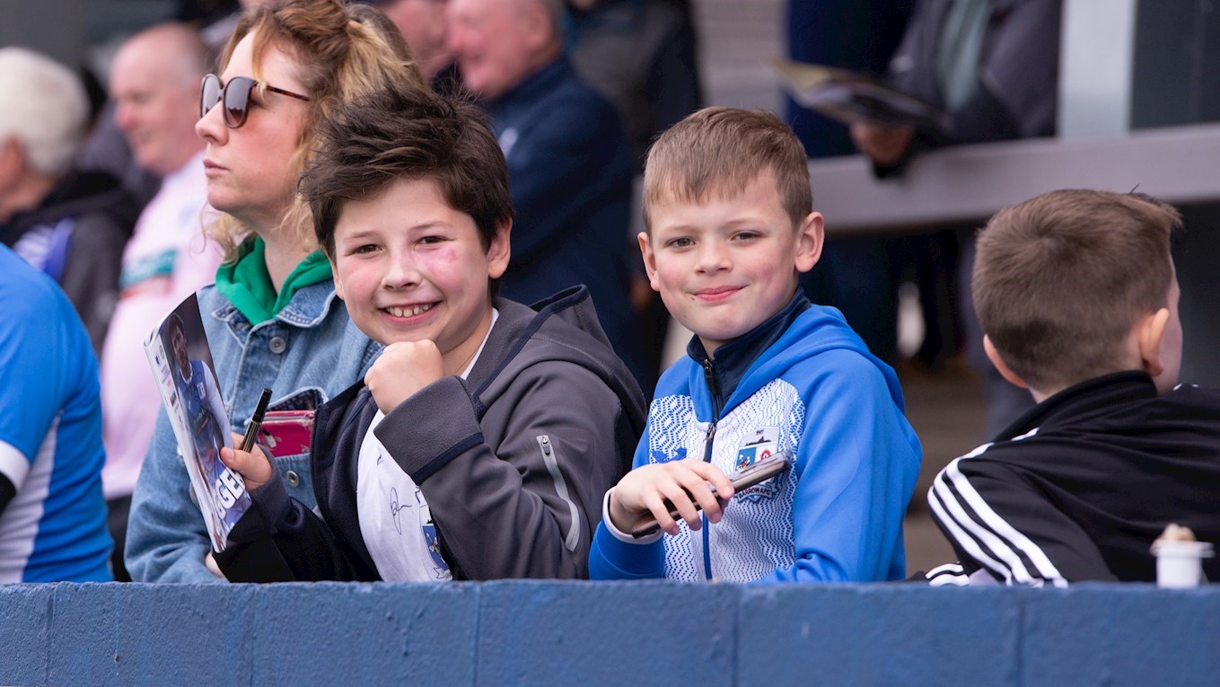 A photograph of young Barrow fans at The Dunes Hotel Stadium
