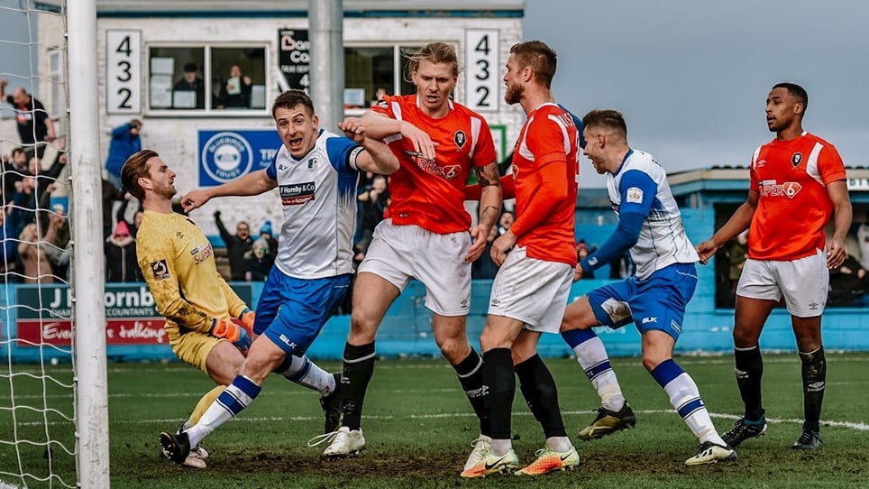 A photo of Jacob Blyth scoring against Salford City at Holker Street with Josh Granite celebrating as the ball hits the net.