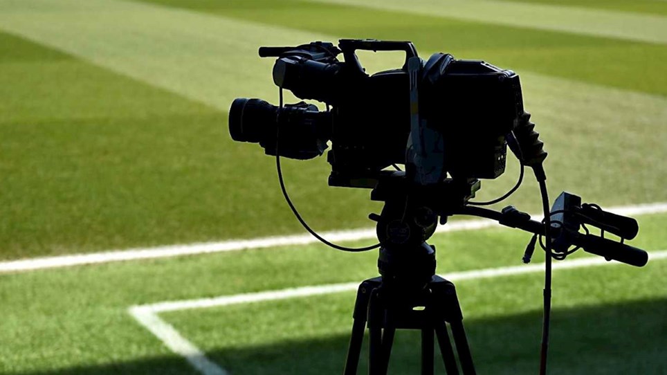 A photo of a television camera at a football stadium