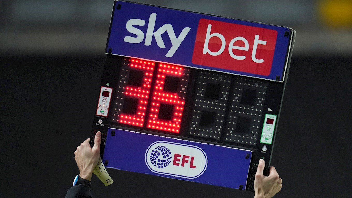 A photograph of the fourth official holding up the electronic substitutions board