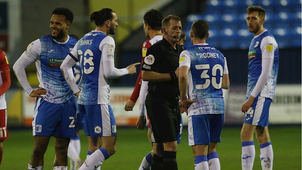 A photograph of the Barrow players reacting to the red card shown to Aaron Amadi-Holloway during the game against Stevenage