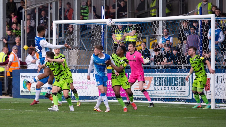 A photograph of Aaron Amadi-Holloway scoring a header for Barrow in the win over Forest Green Rovers
