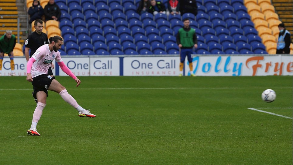 A photograph of Ollie Banks scoring a penalty for Barrow at Mansfield Town