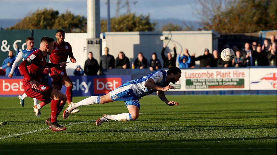 A photograph of Barrow midfielder Ollie Banks scoring against Rochdale