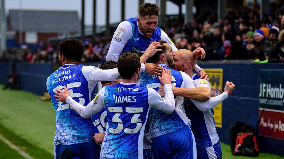A photograph of Barrow players celebrating Ollie Banks