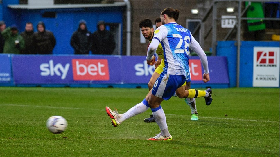 A photograph of Ollie Banks scoring a penalty against Tranmere Rovers for Barrow