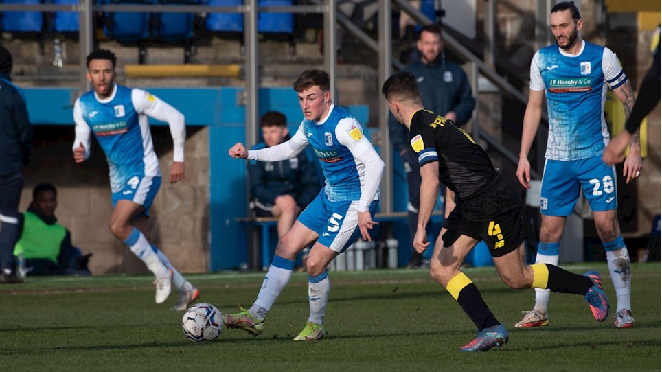 A photograph of Barrow midfielder Robbie Gotts in possession against Harrogate Town