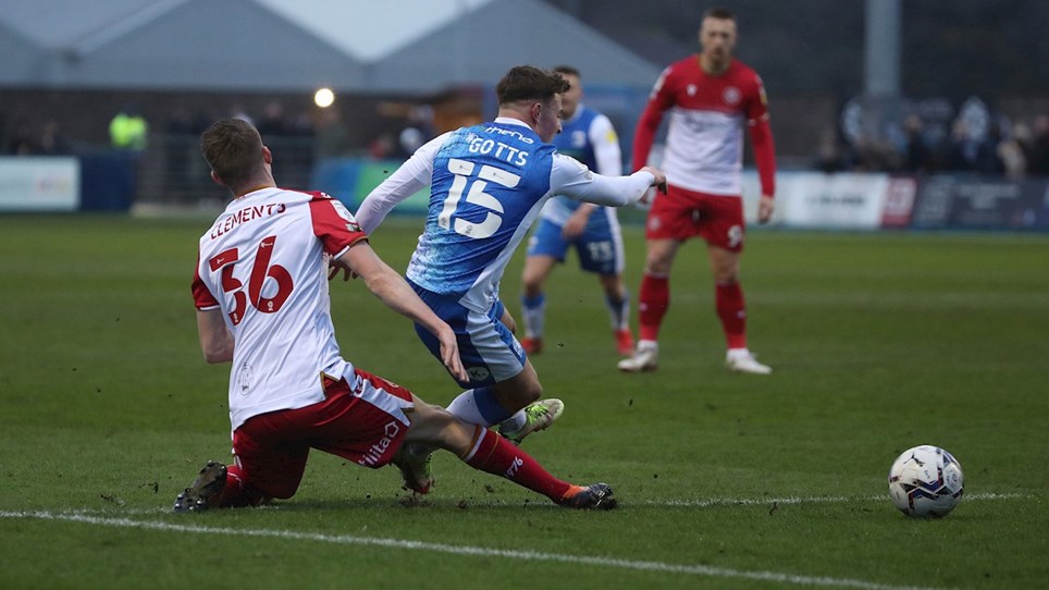 A photograph of Robbie Gotts going down in the area under a challenge from a Stevenage defender