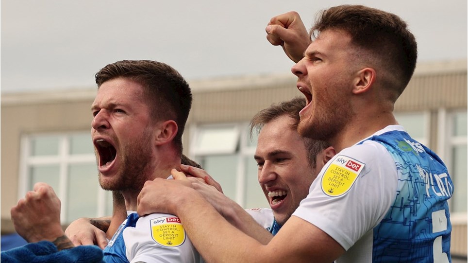 A photograph of Joe Grayson celebrating his goal for Barrow against Forest Green Rovers