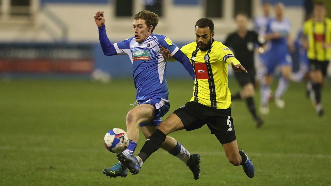 A photograph of Luke James in action against Harrogate Town in March 2021