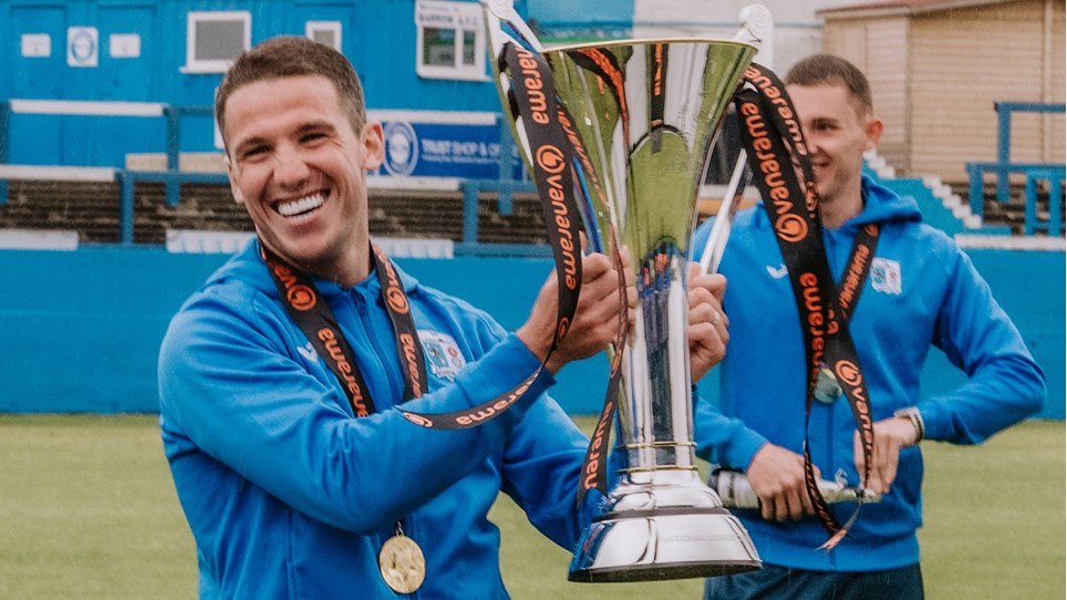 A photograph of John Rooney with the National League trophy after Barrow