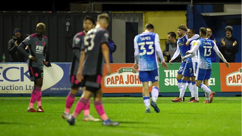 A photograph of Jordan Stevens celebrating with his Barrow teammates after scoring the winner against Leicester City Under 21s