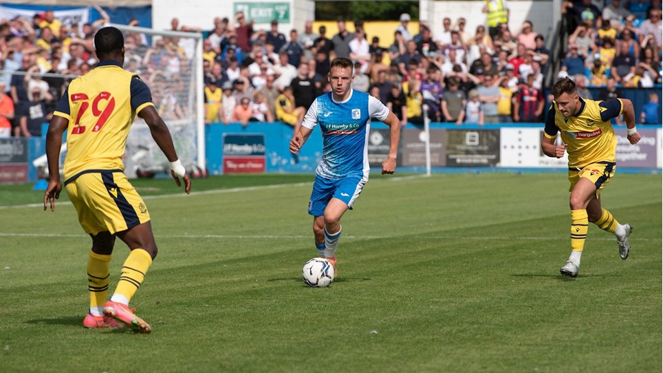 A photograph of Tom White in action for Barrow against Bolton Wanderers