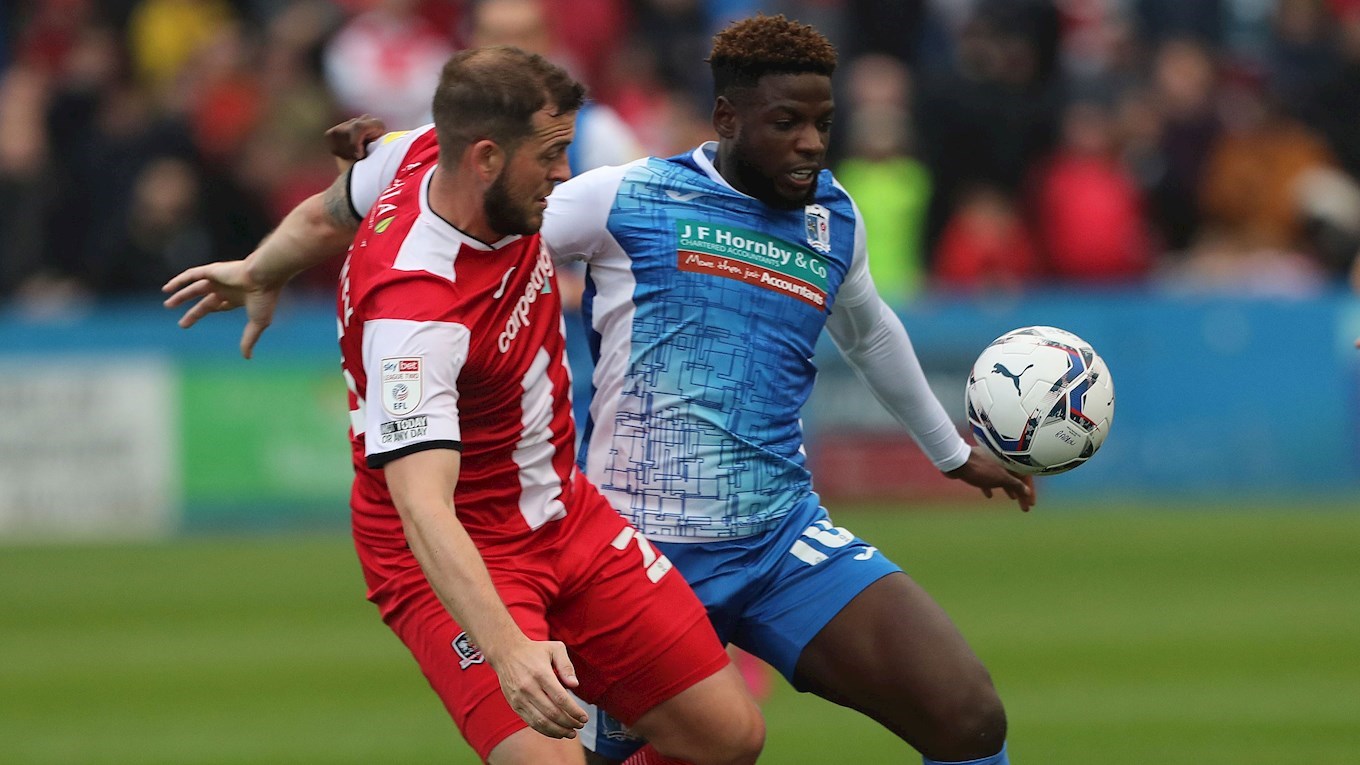A photograph of Offrande Zanzala in action for Barrow against Exeter City