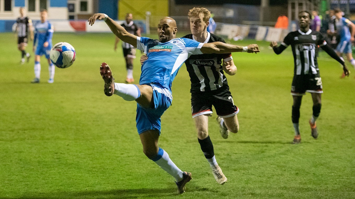 A photograph of Calvin Andrew in action against Grimsby Town