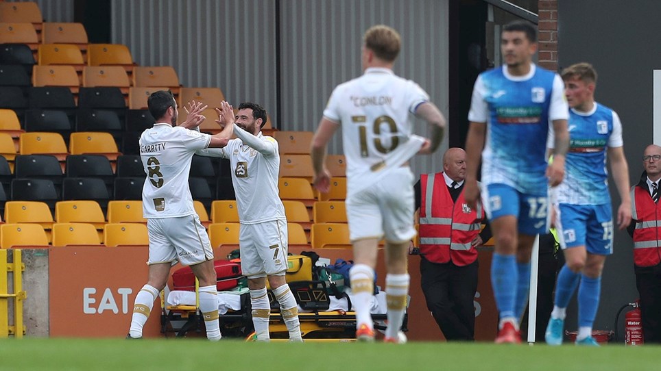A photograph of Port Vale players celebrating a goal against Barrow