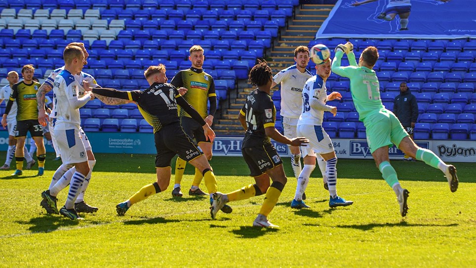 Tom Beadling stretches for the ball as the Tranmere Rovers keeper punches clear