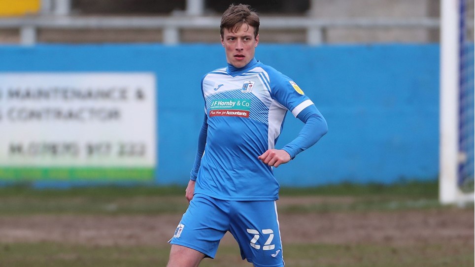 A photograph of Tom Davies in action for Barrow