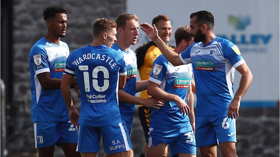 A photograph of Barrow players celebrating Lewis Hardcastle