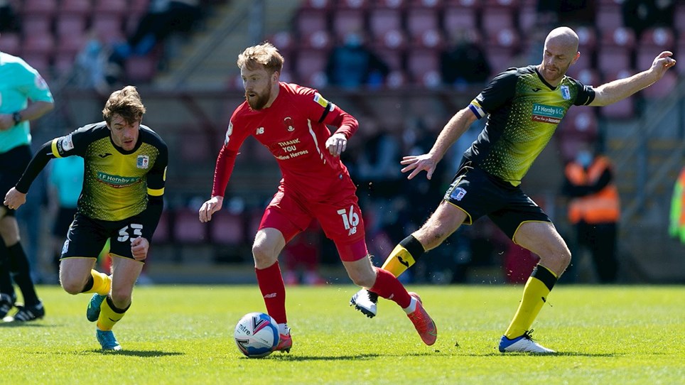 A photograph of Luke James and Jason Taylor in action for Barrow at Leyton Orient in April 2021