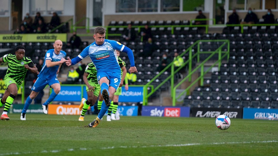 A photograph of Scott Quigley scoring a penalty for Barrow at Forest Green Rovers
