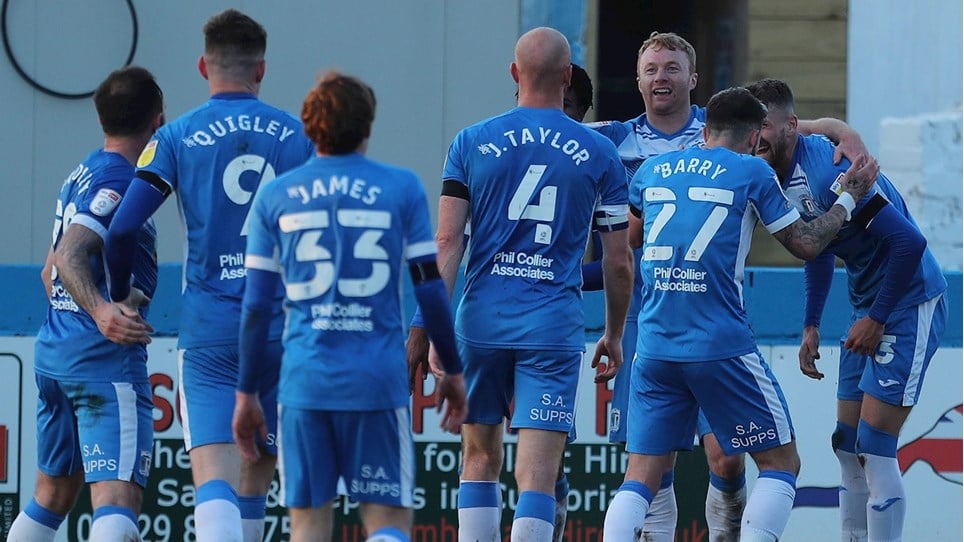 A photograph of the Barrow players celebrating a goal against Exeter City